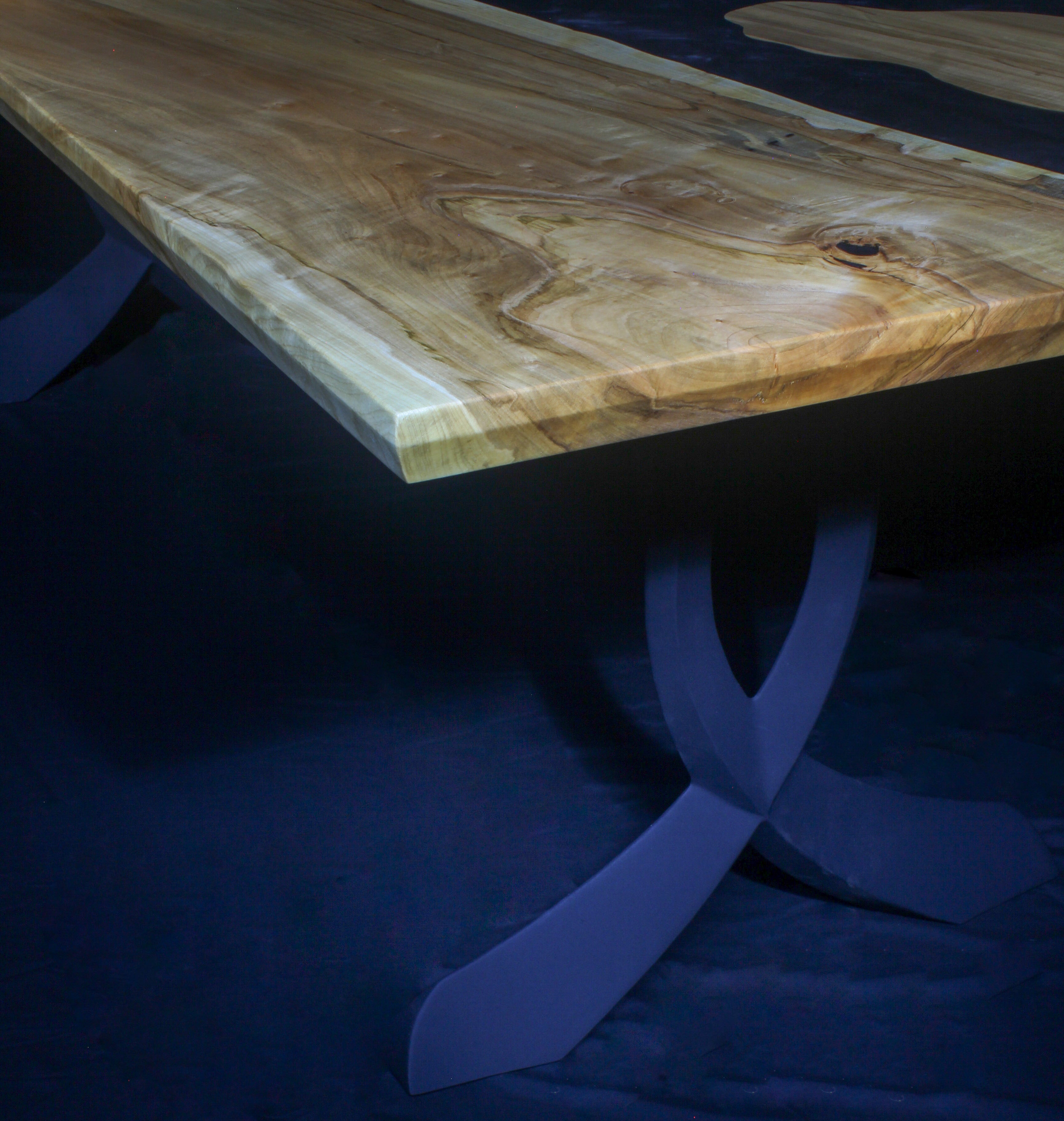 Image of a handcrafted wood table with a blue epoxy river and blue legs